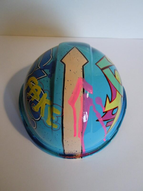 Casque bleu clair, graffé, avec un personnage manga sur le devant.