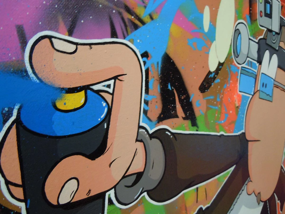 On voit la bombe de peinture bleue que tient le personnage de Wilfried.