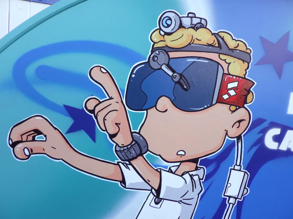Gros plan sur le casque de réalité virtuelle que porte le personnage principal de la peinture. On voit que c'est un casque fait maison. Il est fait de bric et de broc. On dirait un masque de ski auquel on a ajouté des essuis glace et une lampe torche, le tout relié à une batterie de voiture pour l'alimentation électrique.