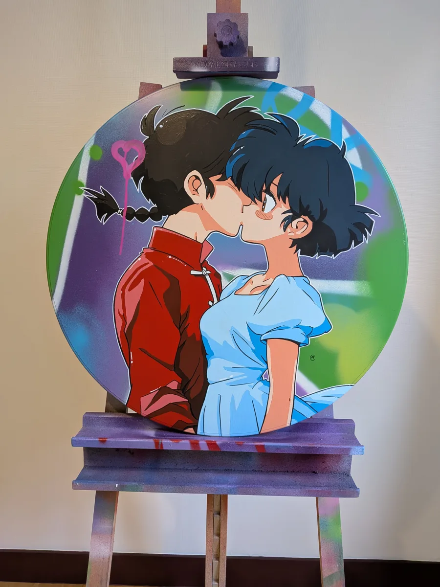 Photo d'un panneau graffé et peint. On y voit les personnages du manga Ranma 1/2, Ranma et Akane s'embrasser.