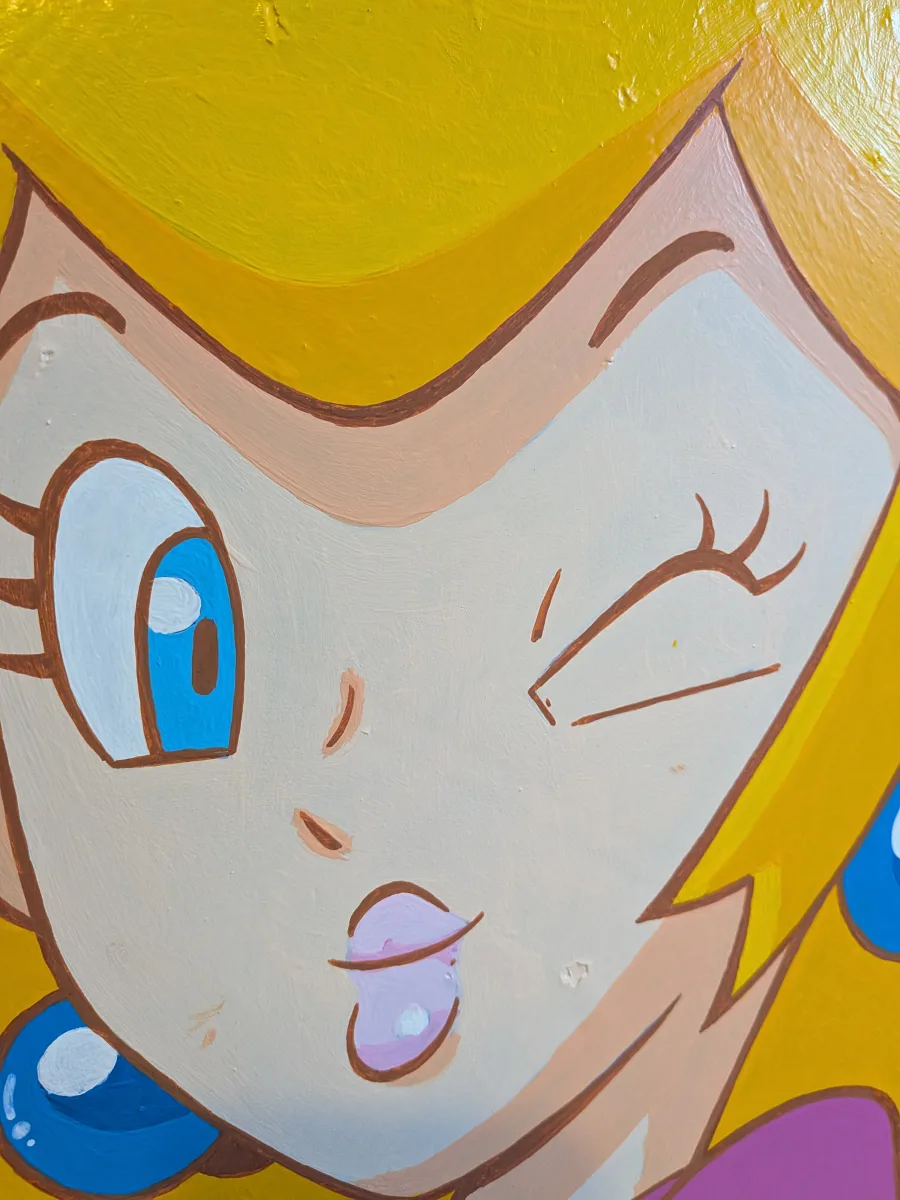 Gros plan saisissant sur le visage de Princesse Peach peint à l’acrylique sur authentique panneau de signalisation octogonal. Œil bleu lagon pétillant, clin d’œil espiègle, petite langue rose et sourire ultra-kawaii. Le contour marron clair très fin et doux (au lieu du noir classique) adoucit incroyablement ses traits, lui donne une tendresse et une rondeur presque veloutée, tout en gardant le style pop parfaitement lisible. Mot-clés : détail visage Peach doux, contour marron clair Peach, peinture acrylique Princess Peach, clin d’œil kawaii Nintendo, tableau gaming visage tendre, pop art doux Mario, décoration geek girly, panneau stop custom Peach, œuvre handmade retrogaming. Rendu chaleureux et réconfortant, pièce unique qui fait fondre les fans de Nintendo et d’art délicat !